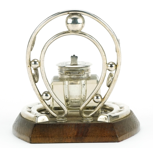 364 - Equestrian interest silver plated and oak horseshoe design pen stand and inkwell, 15.5cm in length