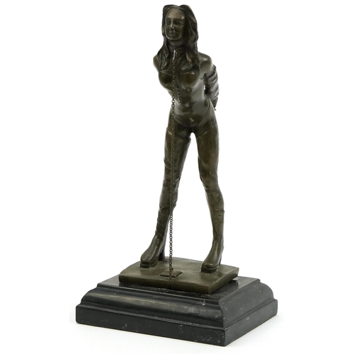 226 - Patinated bronze figure of a dominatrix raised on black slate base, 32cm high