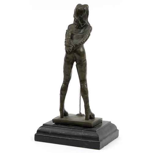 226 - Patinated bronze figure of a dominatrix raised on black slate base, 32cm high