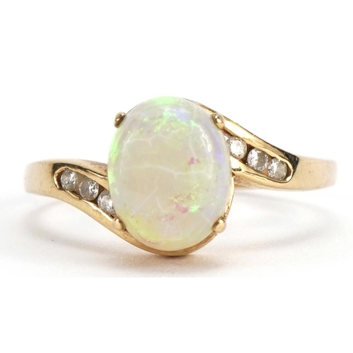 2091 - 9ct gold opal crossover ring with diamond set shoulders, the opal approximately 9.0mm x 7.3mm, size ... 