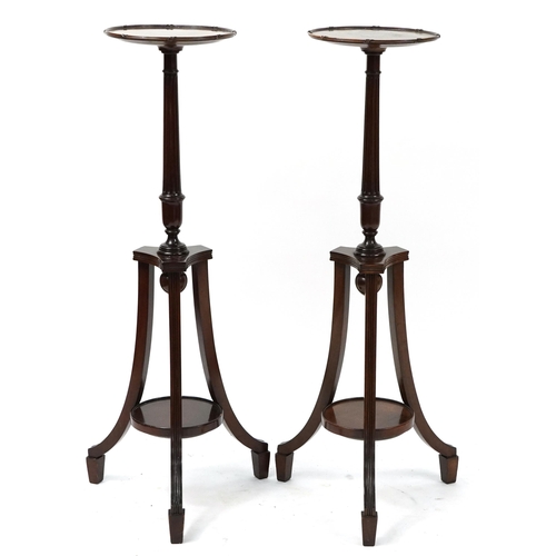 680 - Pair of mahogany tripod jardiniere stands with under tiers, each 106cm high