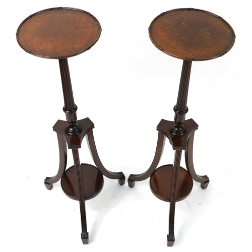 680 - Pair of mahogany tripod jardiniere stands with under tiers, each 106cm high