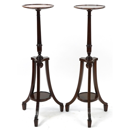 680 - Pair of mahogany tripod jardiniere stands with under tiers, each 106cm high