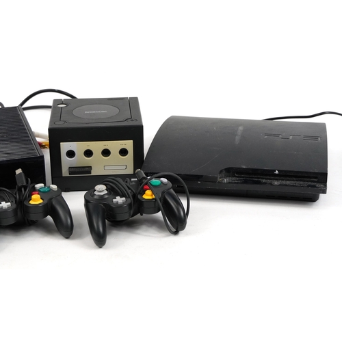 1440 - Three games consoles with controllers comprising Play Station 3, Nintendo Gamecube and Xbox