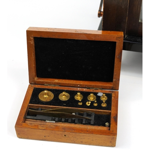 156 - Paul Bunge of Hamburg, set of brass balance scales housed in a glazed oak display case, 43cm H x 36.... 