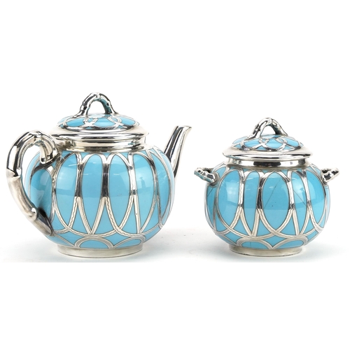 115 - Royal Worcester, Victorian aesthetic silver overlaid porcelain teapot and lidded sugar bowl with twi... 