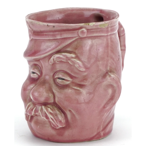 1784 - Military interest pink glazed mug in the form of a Bruce Bairnsfather's Old Bill, 11.5cm high