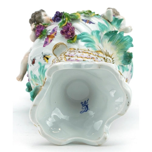 296 - Manner of Dresden, continental porcelain floral encrusted ewer surmounted with two Putti, inscribed ... 