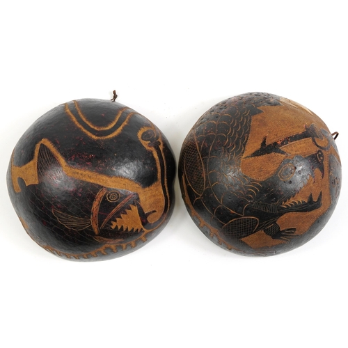 491 - Pair of tribal interest coco de mer bum nut bowls carved with sea creatures, each approximately 23cm... 