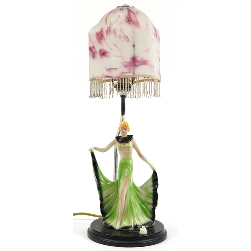 1279 - Art Deco porcelain female dancer table lamp with pink and white mottled glass shade, 48cm high