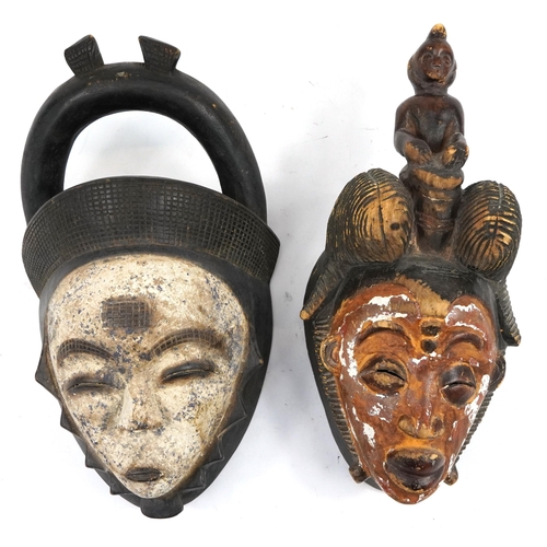 490 - Two African tribal interest partially painted face masks, the largest 36cm high