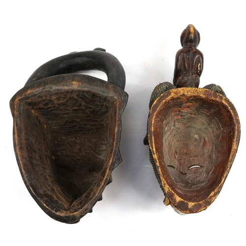 490 - Two African tribal interest partially painted face masks, the largest 36cm high