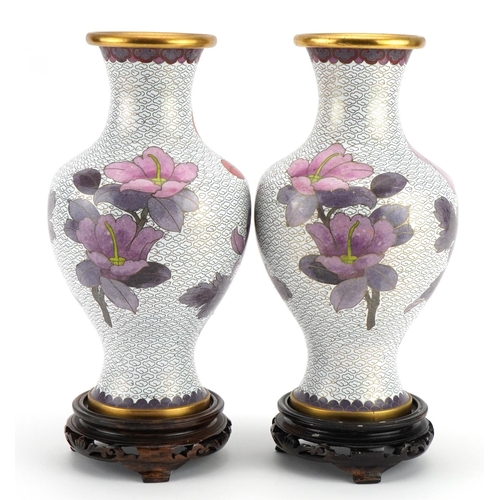 193 - Pair of Chinese cloisonne vases raised on hardwood stands, each enamelled with birds amongst flowers... 