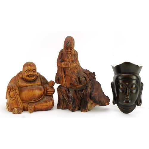 520 - Chino Tibetan patinated cast metal wall plaque in the form of Guanyin and two rootwood carvings, the... 