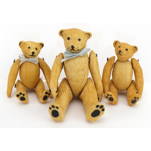 1411 - Three miniature bisque teddy bears with jointed limbs in the manner of Hertwig, the largest 6.5cm hi... 