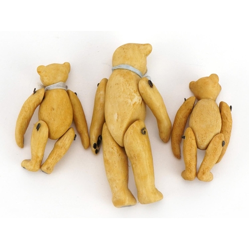 1411 - Three miniature bisque teddy bears with jointed limbs in the manner of Hertwig, the largest 6.5cm hi... 