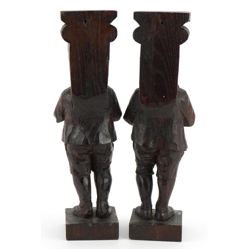 230 - Pair of 18th century oak carvings of pipers, 29cm high