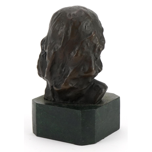 343 - Patinated bronze bust of a female raised on a green marbleised base, 15cm high