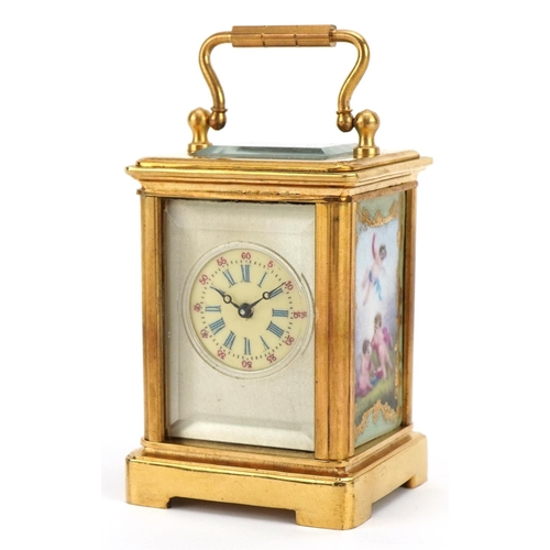 307 - Miniature brass carriage clock with porcelain panels and Roman numeral dial, 6cm high