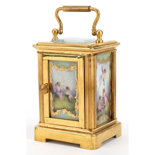 307 - Miniature brass carriage clock with porcelain panels and Roman numeral dial, 6cm high