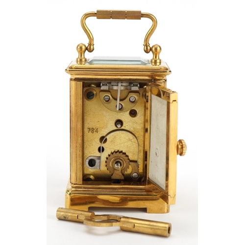 307 - Miniature brass carriage clock with porcelain panels and Roman numeral dial, 6cm high