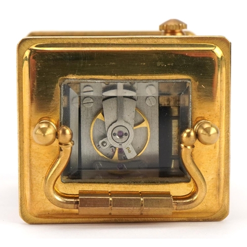 307 - Miniature brass carriage clock with porcelain panels and Roman numeral dial, 6cm high