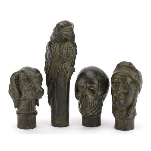 1476 - Four patinated bronze walking stick handles including skull, dog and parrot, the largest 12.5cm high