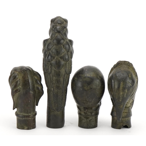 1476 - Four patinated bronze walking stick handles including skull, dog and parrot, the largest 12.5cm high