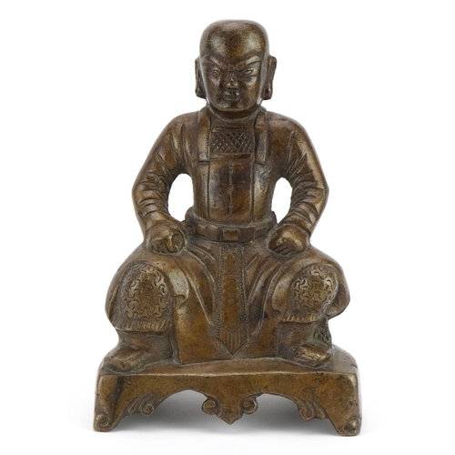 523 - Chino Tibetan bronze figure of a seated warrior, 20.5cm high