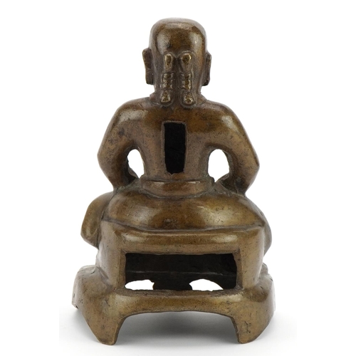 523 - Chino Tibetan bronze figure of a seated warrior, 20.5cm high