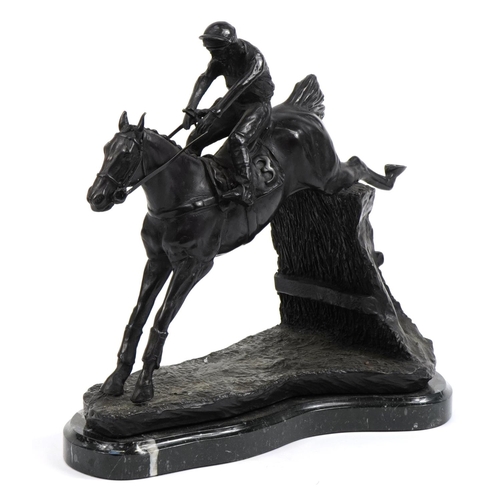 228 - Large patinated bronze study of a jockey on horseback raised on a shaped marble base, 36cm in length