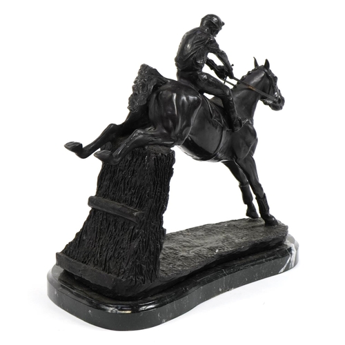 228 - Large patinated bronze study of a jockey on horseback raised on a shaped marble base, 36cm in length