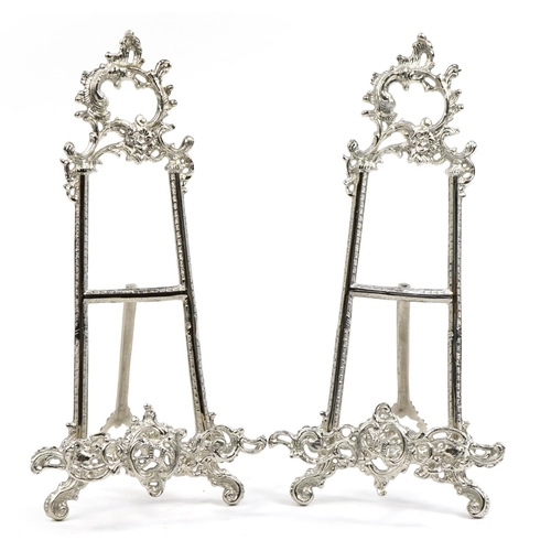 1283 - Pair of Rococo style silvered metal easel stands, each 41cm high