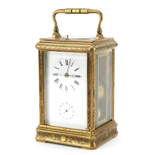 4 - Large brass cased repeating carriage alarm clock engraved with flowers, the enamelled dial with subs... 