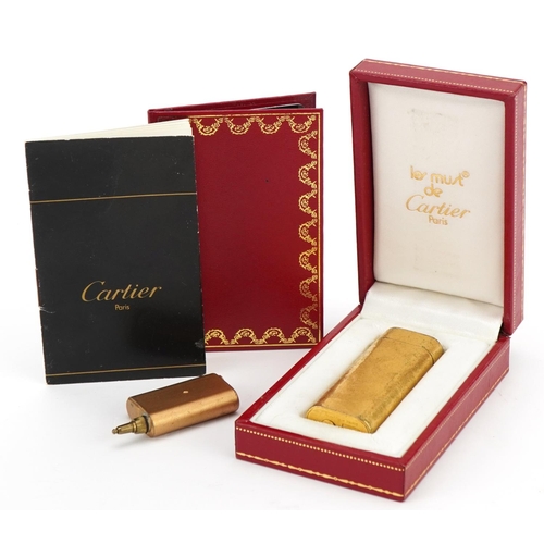 368 - Cartier gold plated pocket lighter with fitted box, guarantee card and wallet