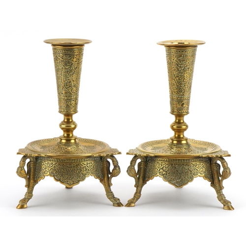 212 - Pair of good quality Indian three footed brass candlesticks engraved with flowers, each 17cm high