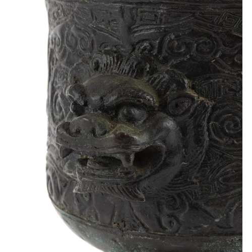 25 - Chinese patinated bronze archaic style vessel with mythical head handles, 21cm high