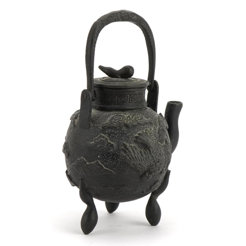 393 - Miniature Asian three footed patinated bronze teapot cast with phoenixes amongst clouds, Chinese or ... 