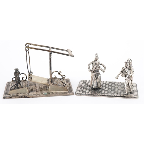 1851 - Two miniature Dutch silver models of figures dancing and a figure waiting to cross a bridge, the lar... 