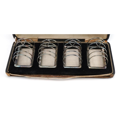 1827 - Adie Brothers Ltd, set of four George V silver four sliced toast racks with ball feet housed in a Co... 