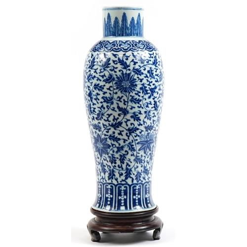 18 - Chinese blue and white porcelain vase hand painted with flowers, raised on carved hardwood stand, 64... 