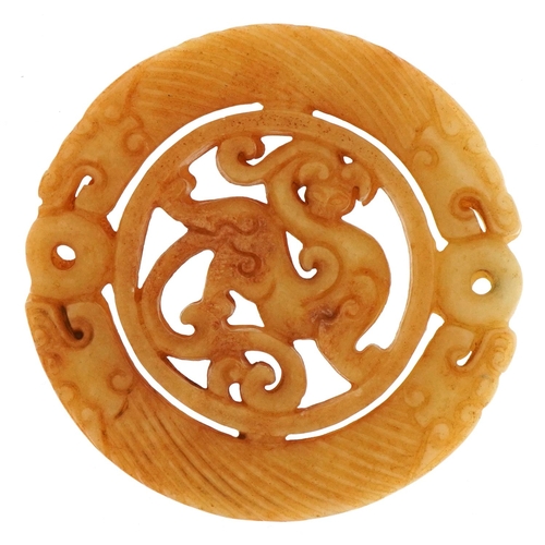 387 - Chinese russet hardstone disk carved with dragons, 7.2cm in diameter, 53.5g