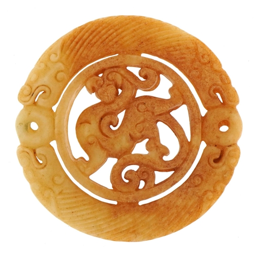 387 - Chinese russet hardstone disk carved with dragons, 7.2cm in diameter, 53.5g