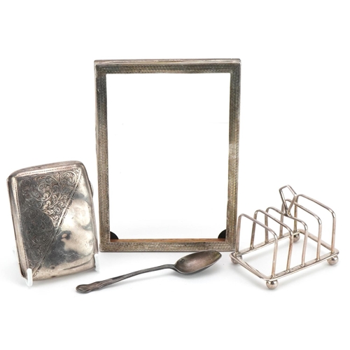 1817 - Silver objects comprising four slice toast rack, cigarette case, rectangular photo frame and a teasp... 