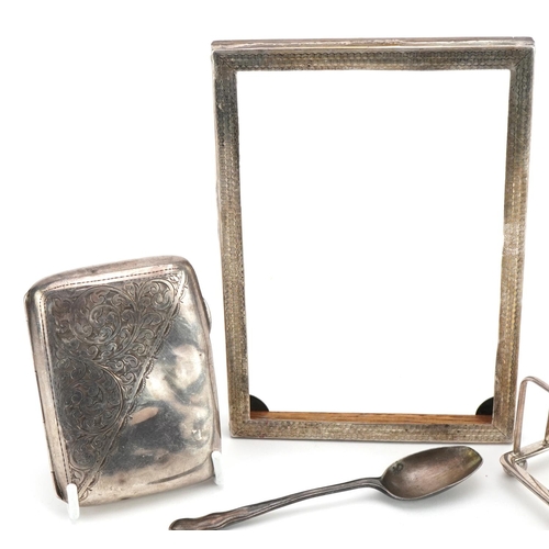 1817 - Silver objects comprising four slice toast rack, cigarette case, rectangular photo frame and a teasp... 