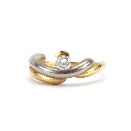 2089 - 18ct two tone gold crossover ring set with a diamond, the diamond approximately 0.19 carat, size O, ... 