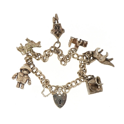 2593 - Silver charm bracelet with a selection of mostly silver charms including Paddington Bear with moving... 