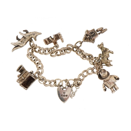 2593 - Silver charm bracelet with a selection of mostly silver charms including Paddington Bear with moving... 