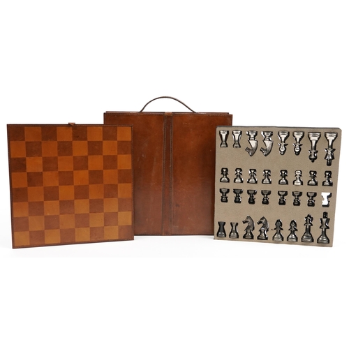 1448 - Tan leather cased travelling chess set with cast metal pieces, the largest piece 8cm high