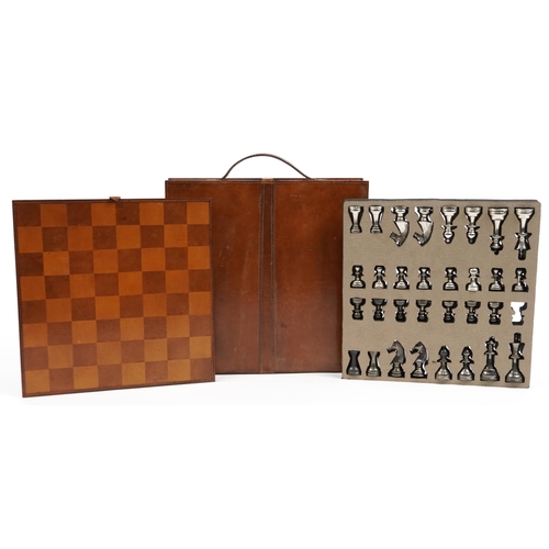 1448 - Tan leather cased travelling chess set with cast metal pieces, the largest piece 8cm high